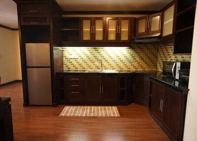 Modern kitchen with wooden cabinets and stainless steel appliances