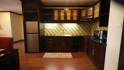 Modern kitchen with wooden cabinets and stainless steel appliances