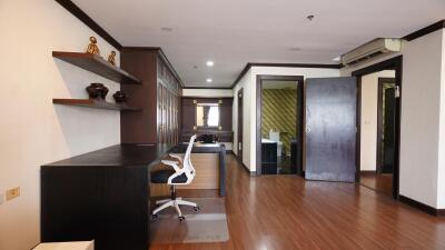 Modern home office with wooden shelves and large desk