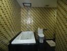 Modern bathroom with golden mosaic tiles and black fixtures