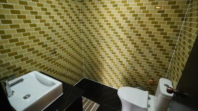 Modern bathroom with golden mosaic tiles