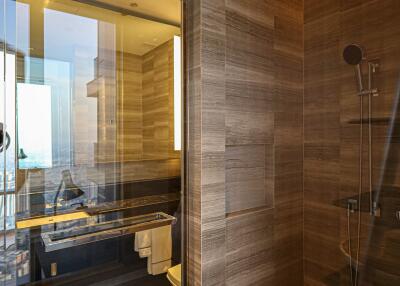 Contemporary bathroom with glass shower enclosure and wood styling