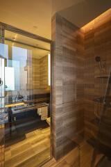 Contemporary bathroom with glass shower enclosure and wood styling