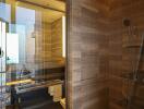 Contemporary bathroom with glass shower enclosure and wood styling