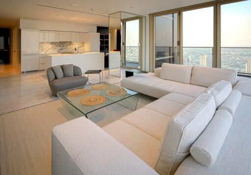 Modern living room in a high-rise with city views and open-designed kitchen