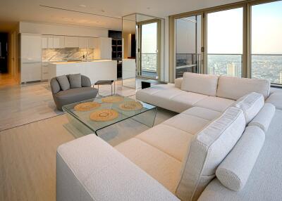 Modern living room in a high-rise with city views and open-designed kitchen