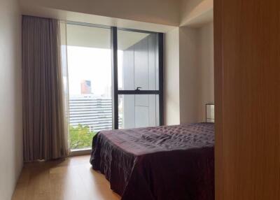 Cozy bedroom interior with floor-to-ceiling windows