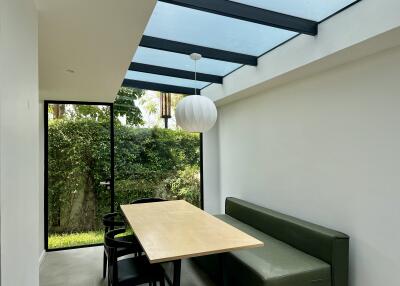 Modern dining area with natural light and garden view