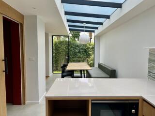 Modern kitchen with natural light, skylight, and dining area