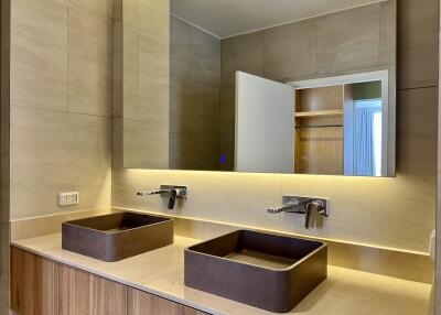 Modern bathroom with double sinks and LED mirror lighting