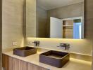 Modern bathroom with double sinks and LED mirror lighting