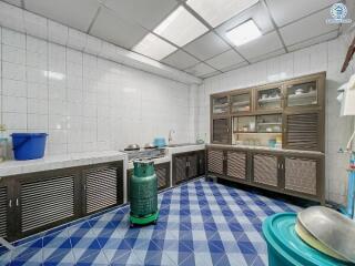 Spacious kitchen with blue patterned tiles and ample storage cabinets