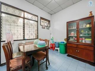 Bright dining room with traditional furniture and large windows