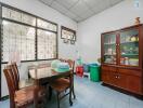 Bright dining room with traditional furniture and large windows