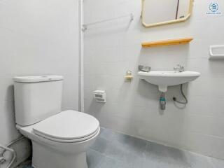 Compact white bathroom with toilet and sink