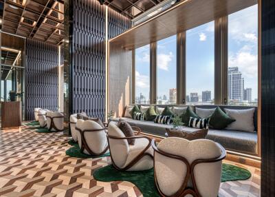 Modern lounge area with floor-to-ceiling windows and city skyline view