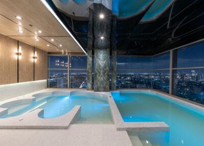 Luxurious indoor swimming pool with city skyline view