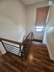 Wooden floored staircase with metal balustrade inside a modern home