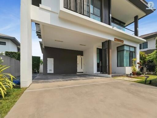 Modern two-story home with spacious driveway and carport