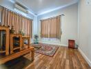 Spacious and well-lit living room interior with wooden flooring