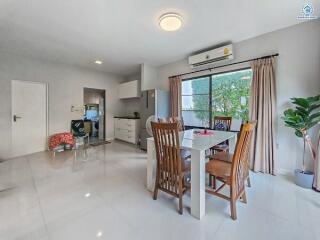 Spacious open plan living and dining area with modern furniture and ample natural light