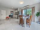 Spacious open plan living and dining area with modern furniture and ample natural light