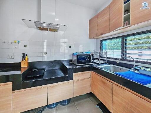 Modern kitchen with wooden cabinets and stainless steel appliances