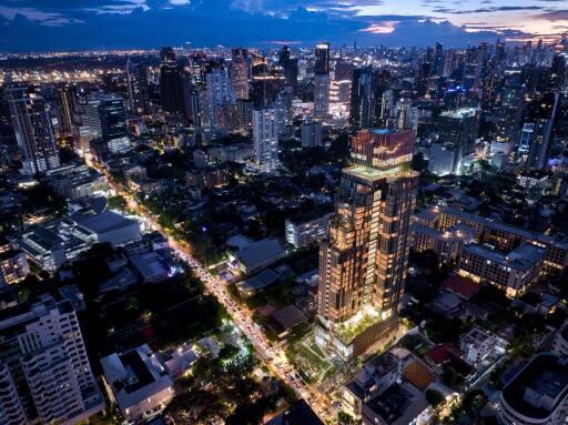 Aerial view of a city at twilight with illuminated buildings