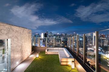 Modern balcony with city skyline view at dusk