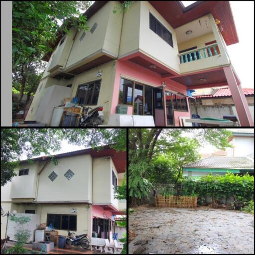 two-story residential building with surrounding greenery