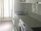 Modern laundry room with washing machine and shelving units