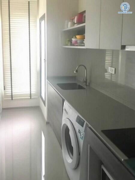 Modern laundry room with washing machine and shelving units