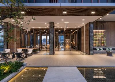 Modern apartment building lobby with stylish design, seating area, and illuminated interiors