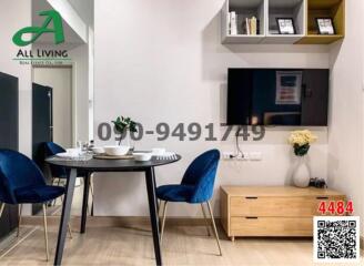 Modern dining area with blue velvet chairs and a sleek round table