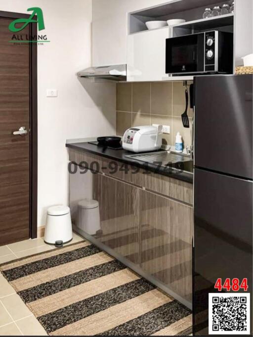 Modern kitchen with stainless steel appliances and black cabinetry