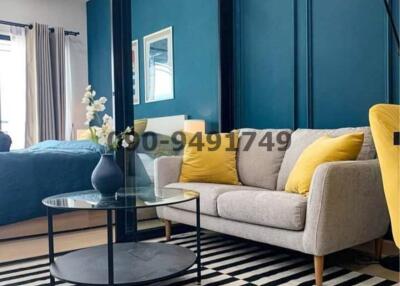 Cozy and modern living room with blue walls and comfortable seating