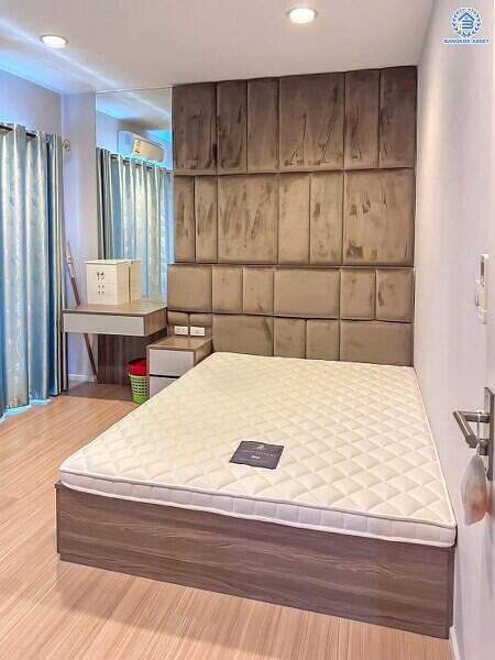 Modern bedroom with a large bed and artistic headboard