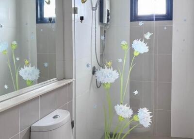 Modern bathroom with flower decals on shower glass