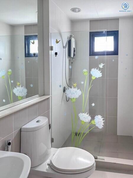Modern bathroom with flower decals on shower glass