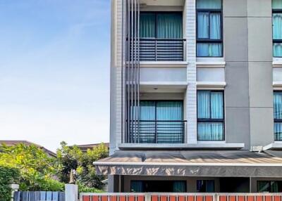 Modern residential building exterior with clear blue sky