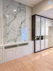 Modern kitchen with marble backsplash and white cabinetry