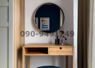 Modern bedroom vanity with round mirror and stylish stool