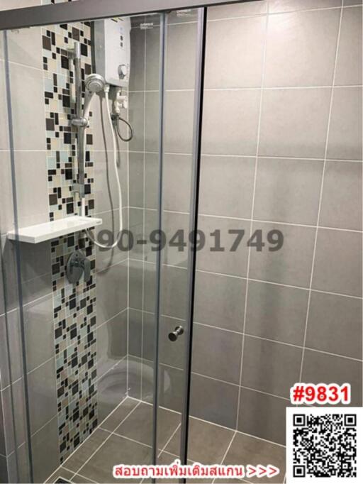 Modern bathroom with glass shower enclosure and tiled walls