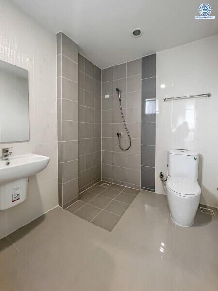 Modern bathroom with walk-in shower, wall-mounted toilet, and sink