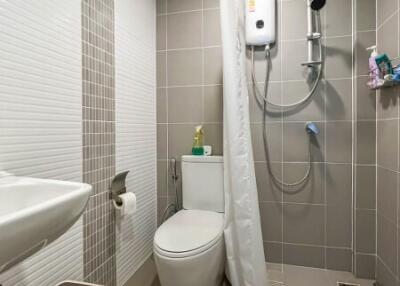 Compact bathroom with modern fixtures and tiled walls