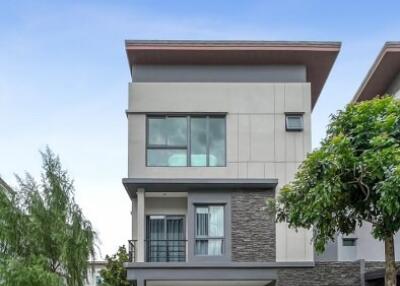 Modern two-storey house with a gray and white facade and attached garage