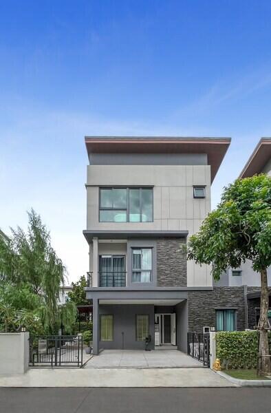 Modern two-storey house with a gray and white facade and attached garage