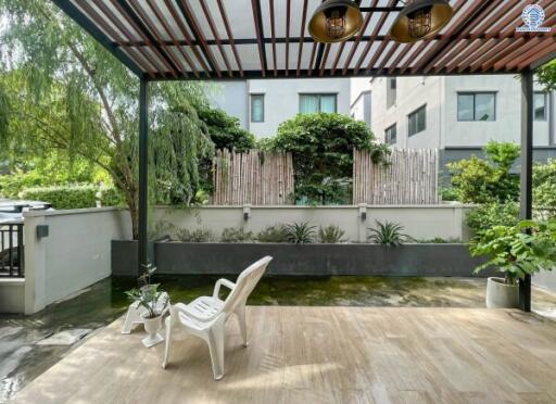 Spacious patio area with greenery and outdoor seating