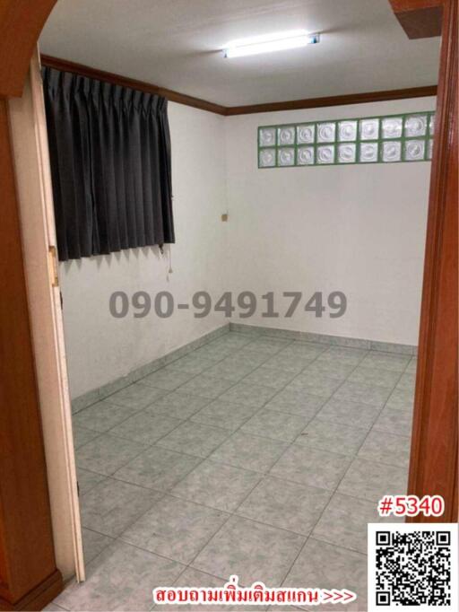 Empty room with tiled floor and black curtains