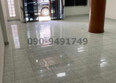 Spacious interior of a building with shiny tiled flooring and pillar